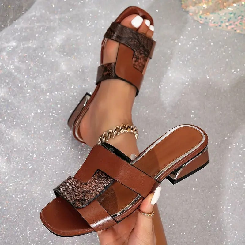 Brown orthopedic sandal close-up with chunky heel, open toe, and wide strap