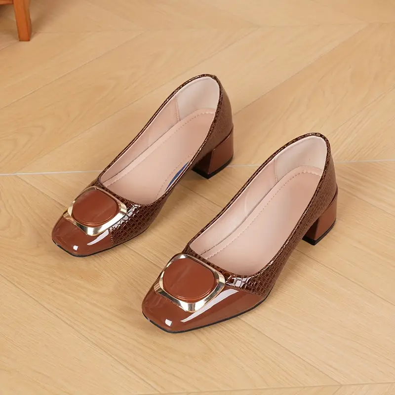 Pair of brown leather loafers with square gold buckle accents and low block heel