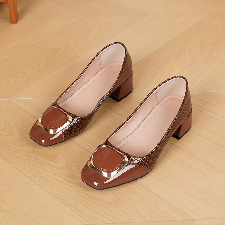 Pair of brown leather loafers with square gold buckle accents and low block heel