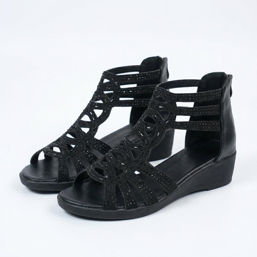 Black orthopedic sandals with layered cutout straps and wedge sole
