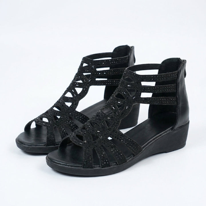 Black orthopedic sandals with layered cutout straps and wedge sole