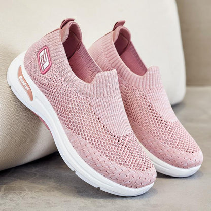 Light pink slip-on knit shoes with white sole and cushioned heel collar