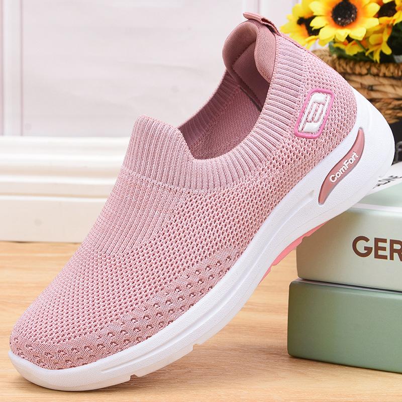 Pink slip-on knit shoes with white sole and side comfort logo