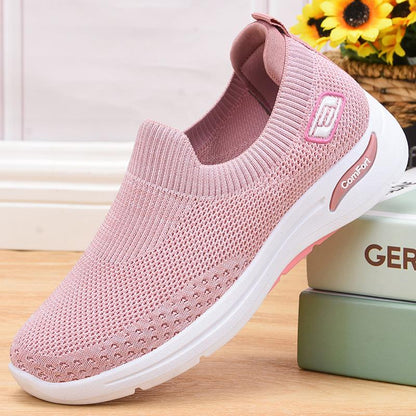 Pink slip-on knit shoes with white sole and side comfort logo