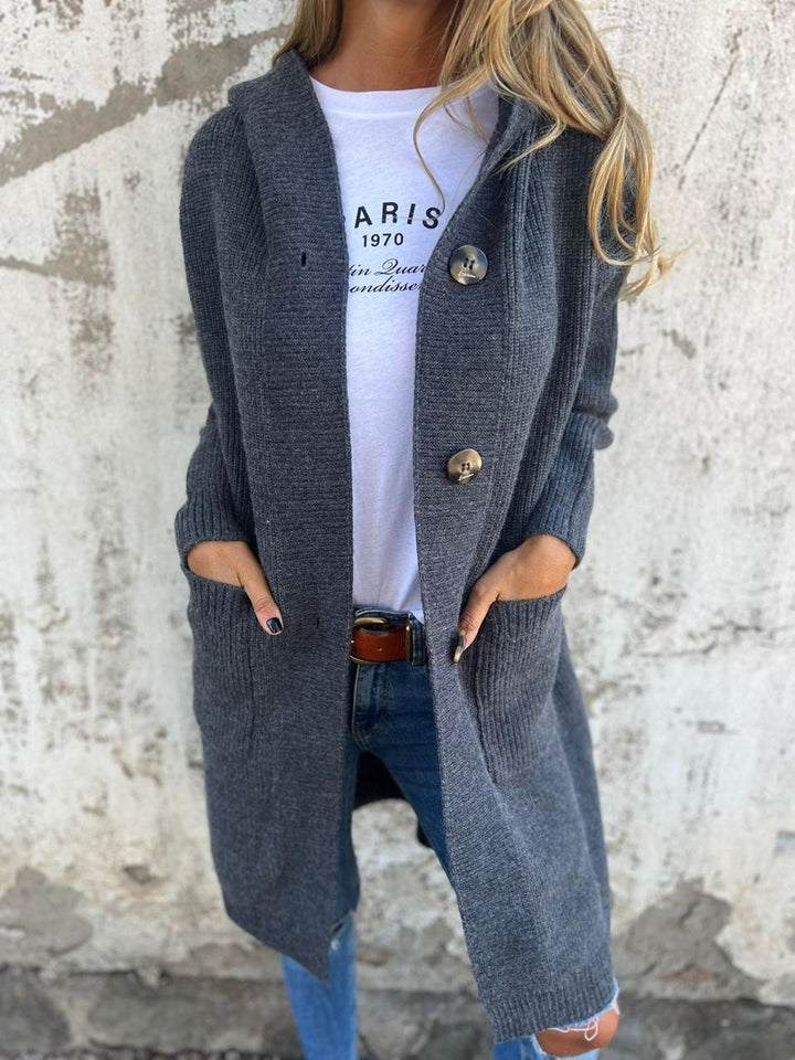 Dark gray long knit cardigan with hood and large round button closures.