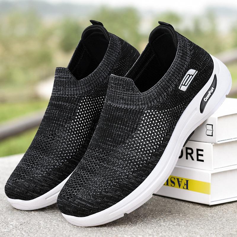 Black slip-on knit shoes with white sole and comfort logo patch