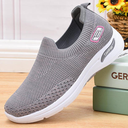 Gray slip-on knit shoes with white sole and comfort logo on side