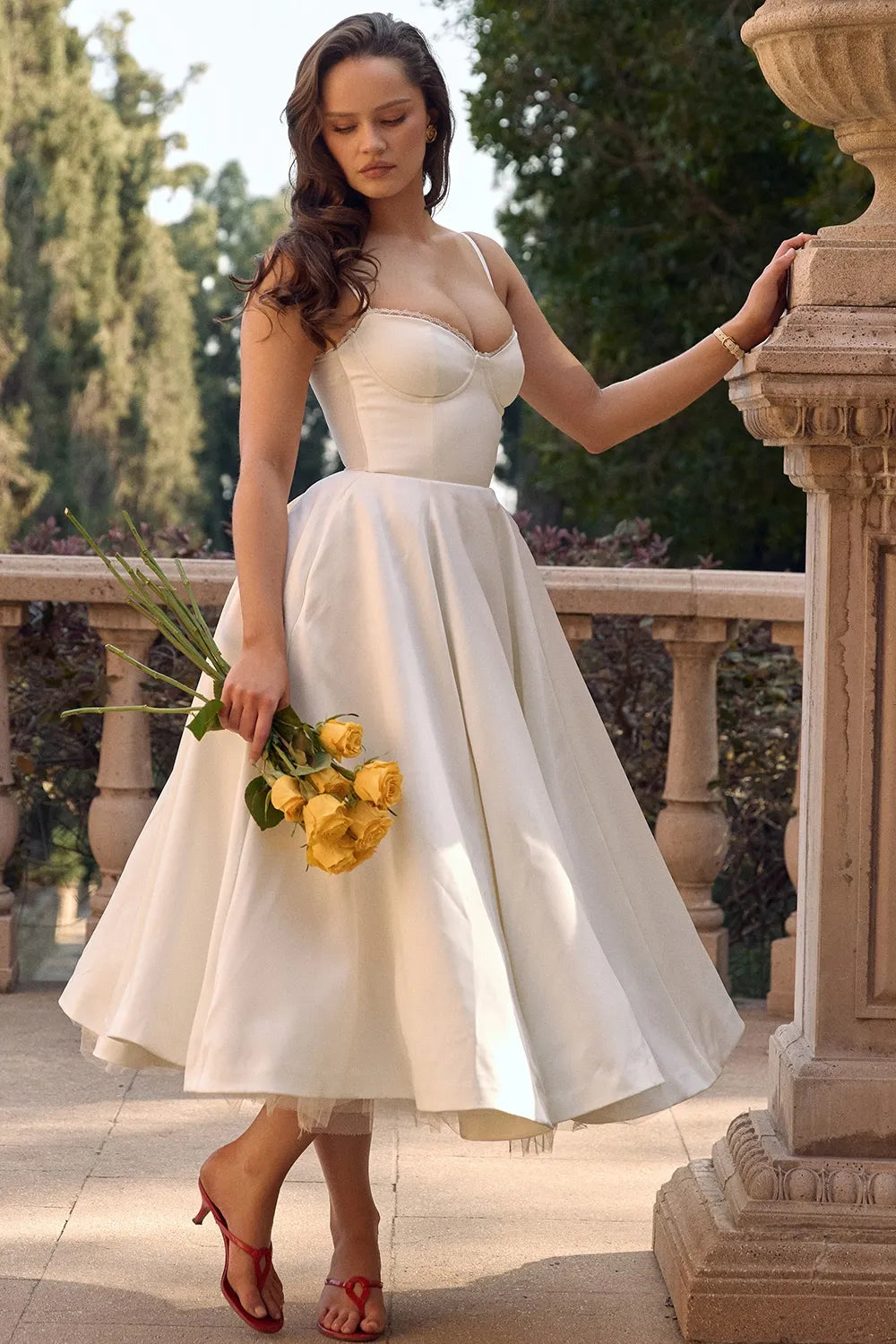White satin midi dress with sweetheart bodice, spaghetti straps, and flared tulle skirt