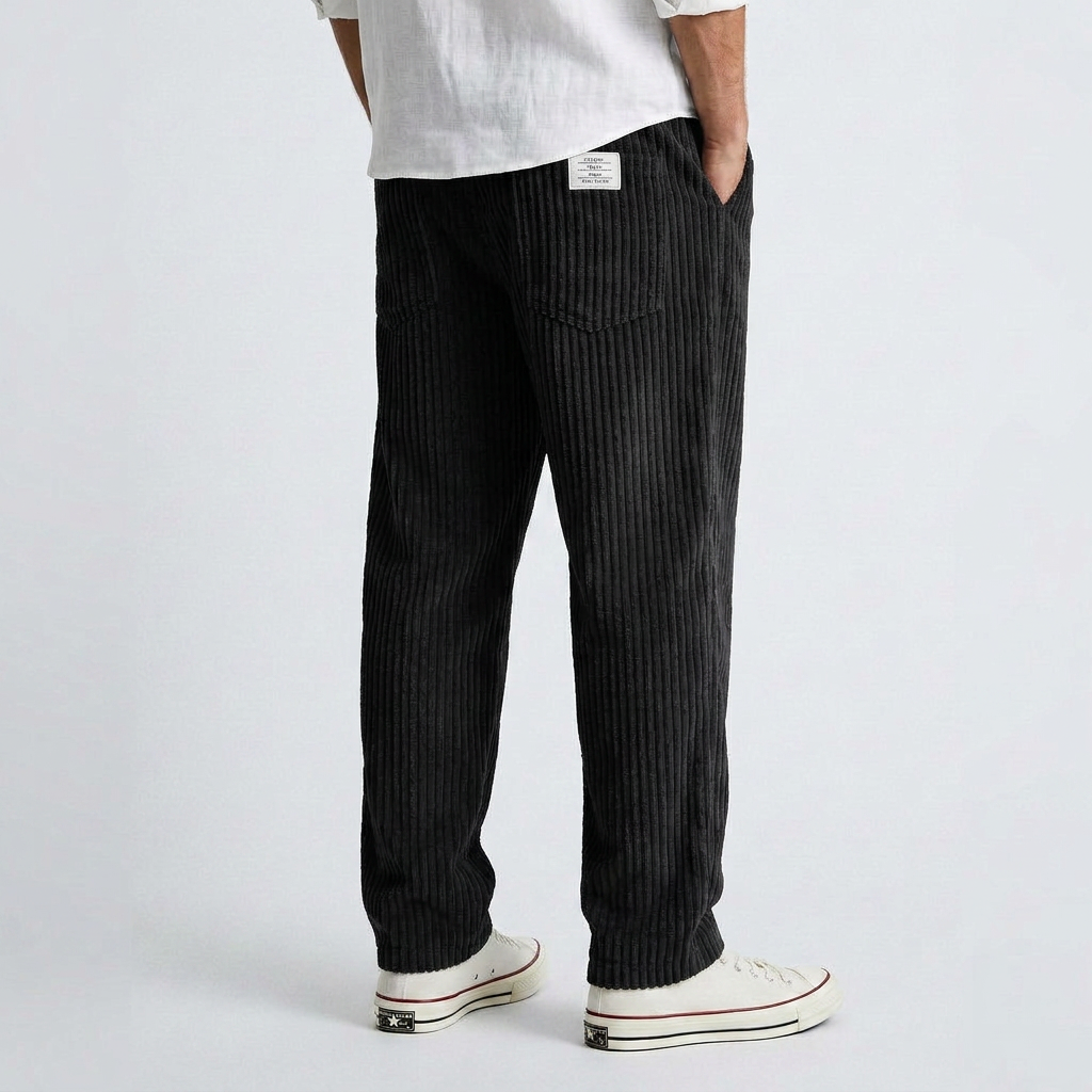 Black wide-leg corduroy pants with vertical ribbed texture and relaxed fit.