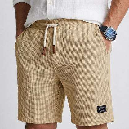 Beige textured knit shorts with drawstring elastic waist and side pockets