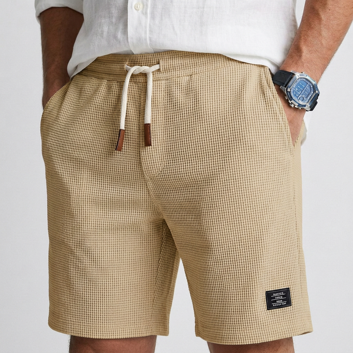 Beige textured knit shorts with drawstring elastic waist and side pockets