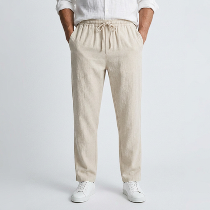 Beige linen pants with elastic drawstring waist and relaxed straight legs
