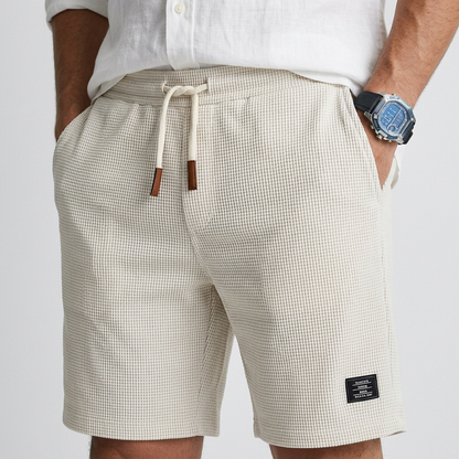 Casual textured knit shorts, white with small check pattern, elastic waist and drawstring.