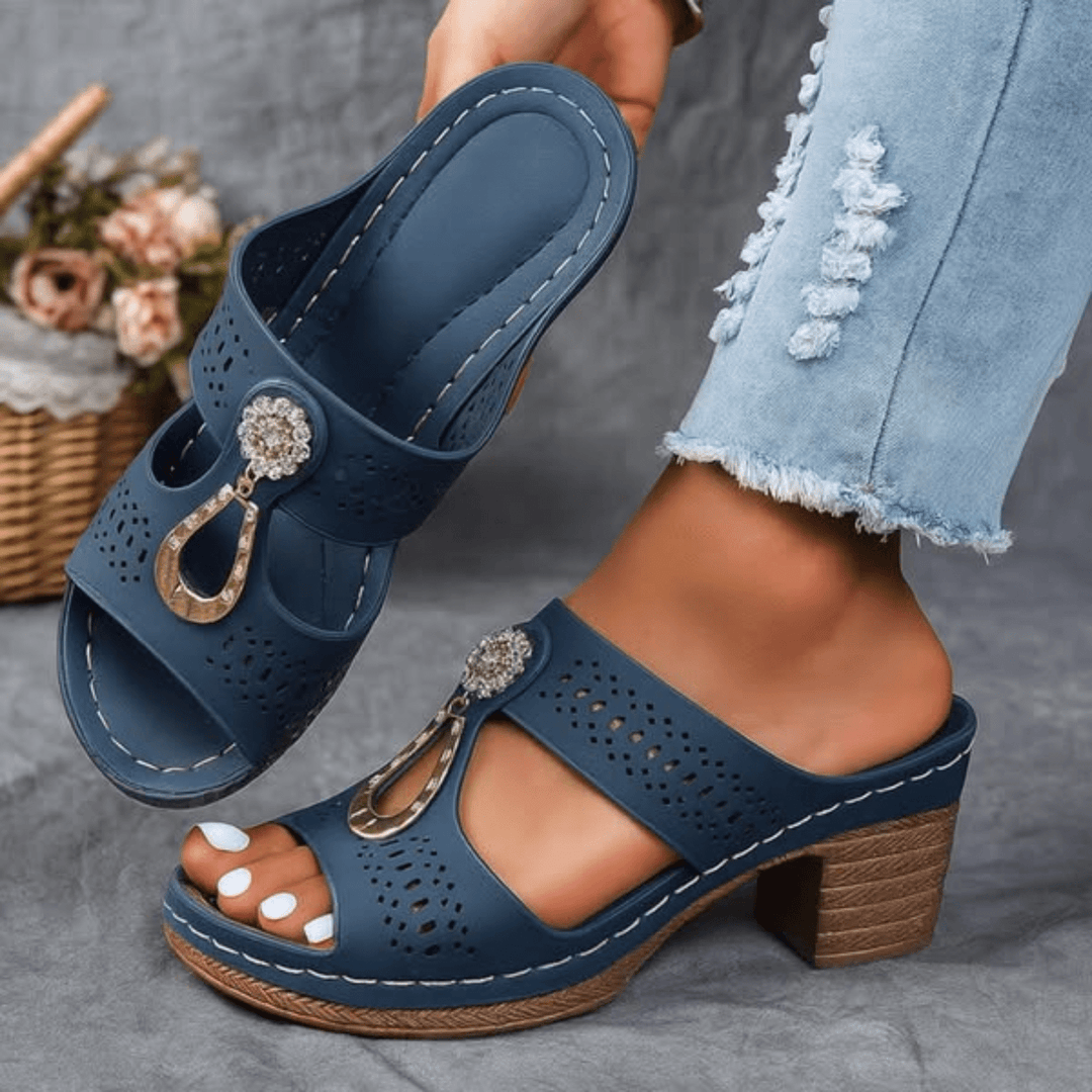 Orthopedic blue slide sandals with perforations, ankle strap, gold-tone buckle, cushioned footbed