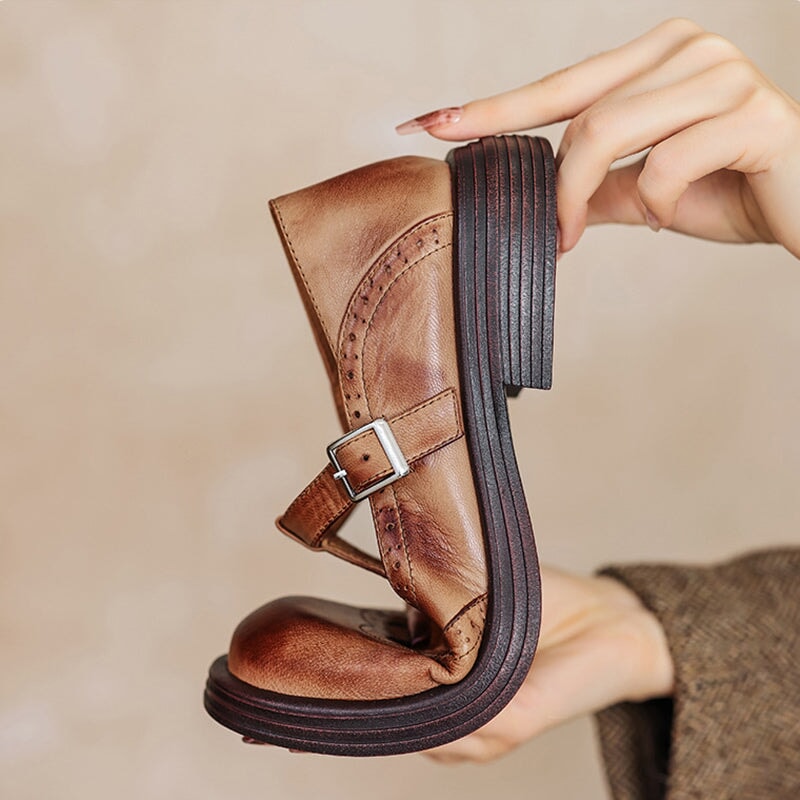 Brown leather Mary Jane shoe showing buckle strap and thick ribbed sole.
