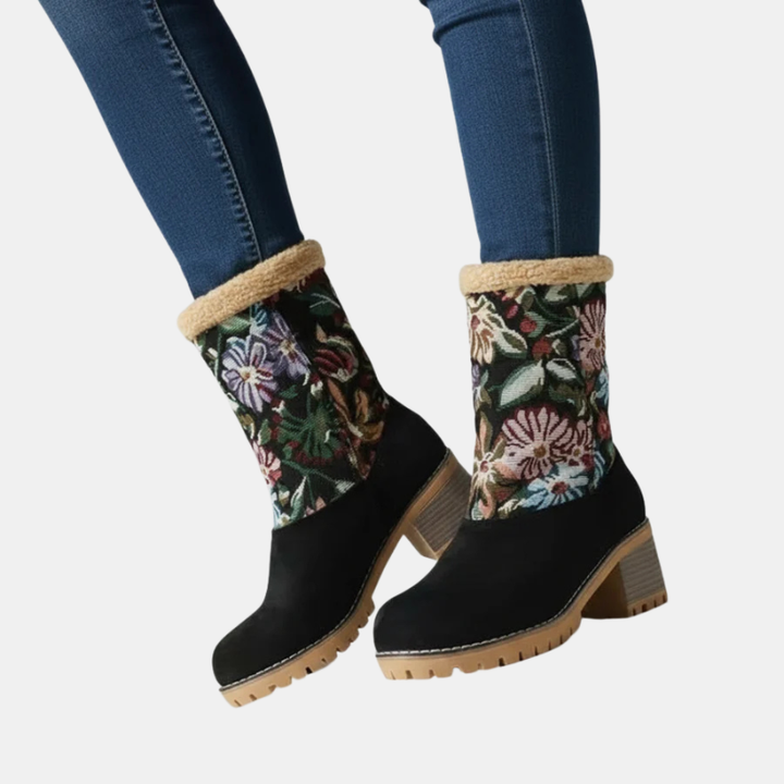 Ankle boots in black with floral fabric cuffs and tan block heel, lug sole