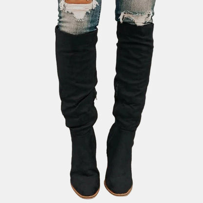Black slouchy heeled knee-high boots with stacked block heel and pointed toe