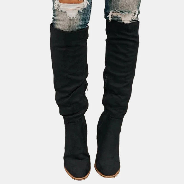 Black slouchy heeled knee-high boots with stacked block heel and pointed toe