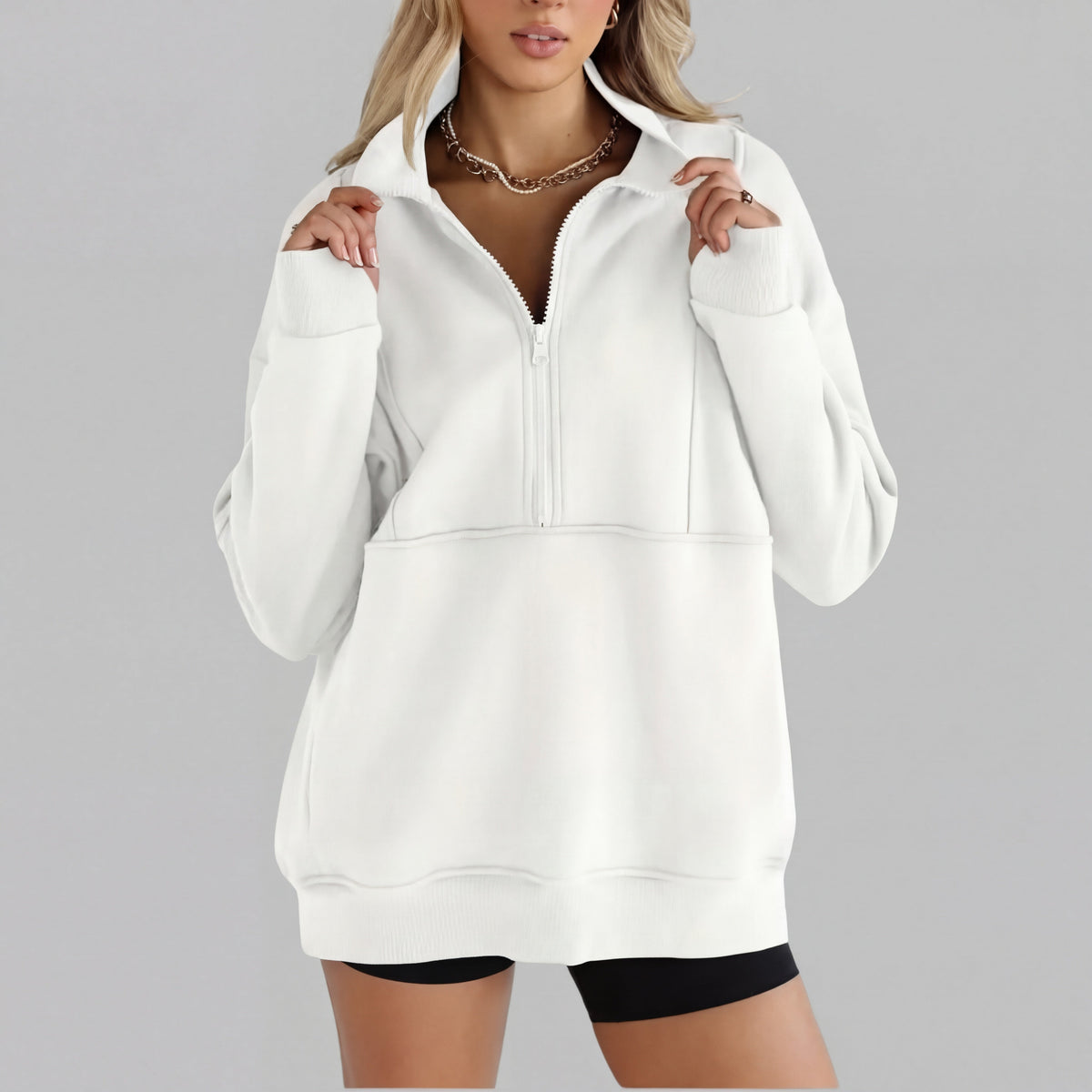 White oversized half-zip sweatshirt with front zipper and kangaroo pocket, ribbed cuffs