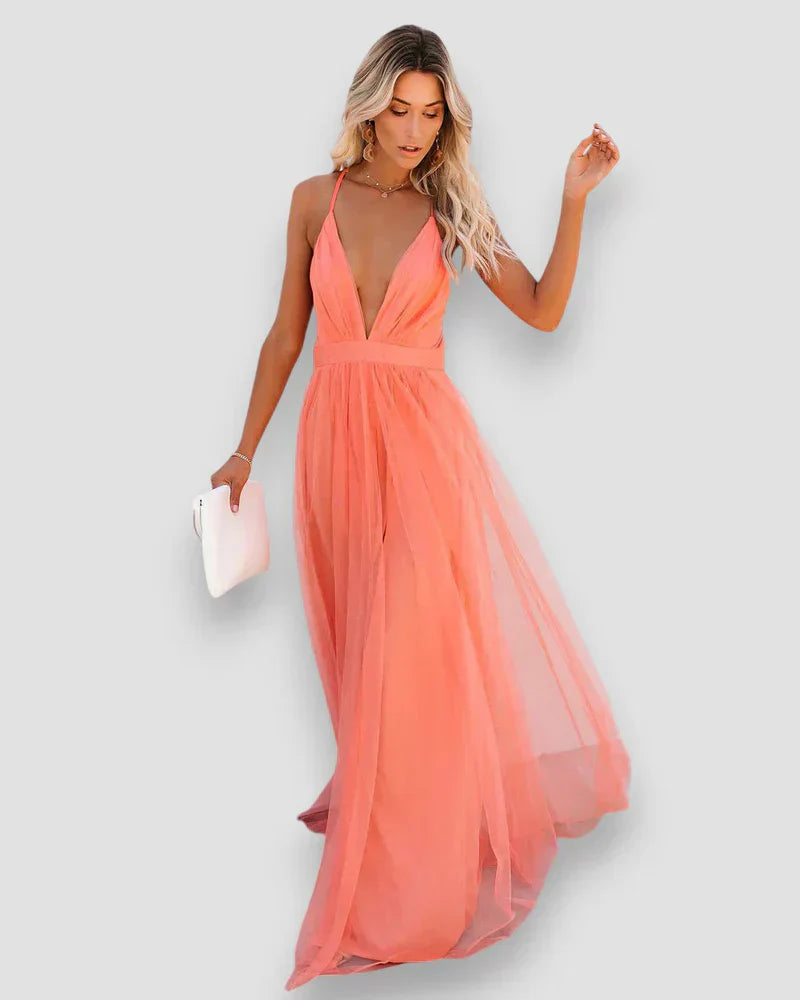 Coral pink halter maxi dress with fitted bodice and flowing tulle skirt