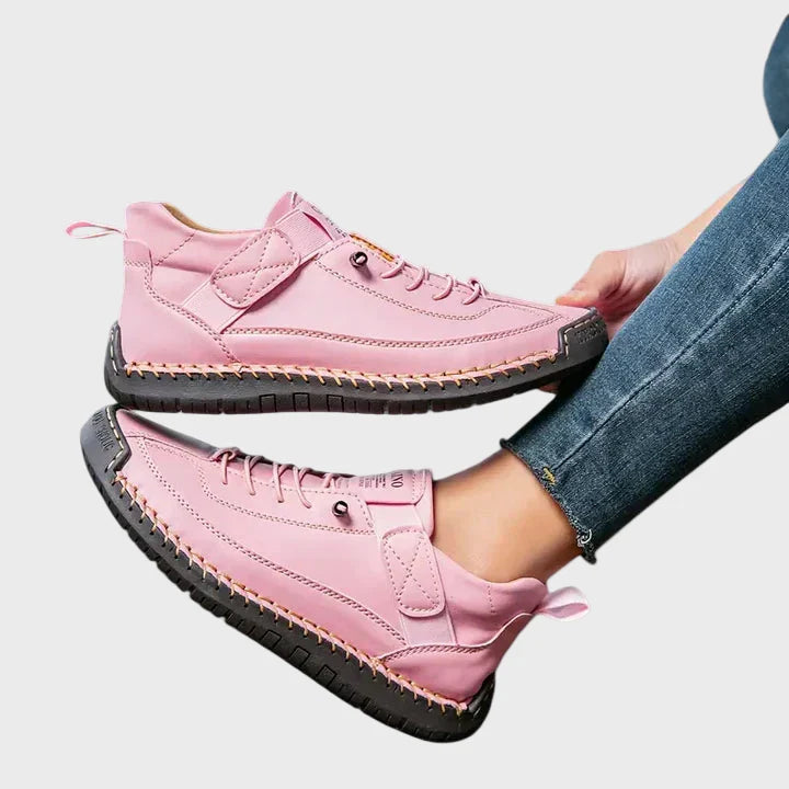 Orthopedic sneakers in pink with lace-up front, ankle strap, and textured rubber outsole