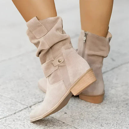 Beige suede ankle boots with side zipper, decorative buckle strap, and low block heel