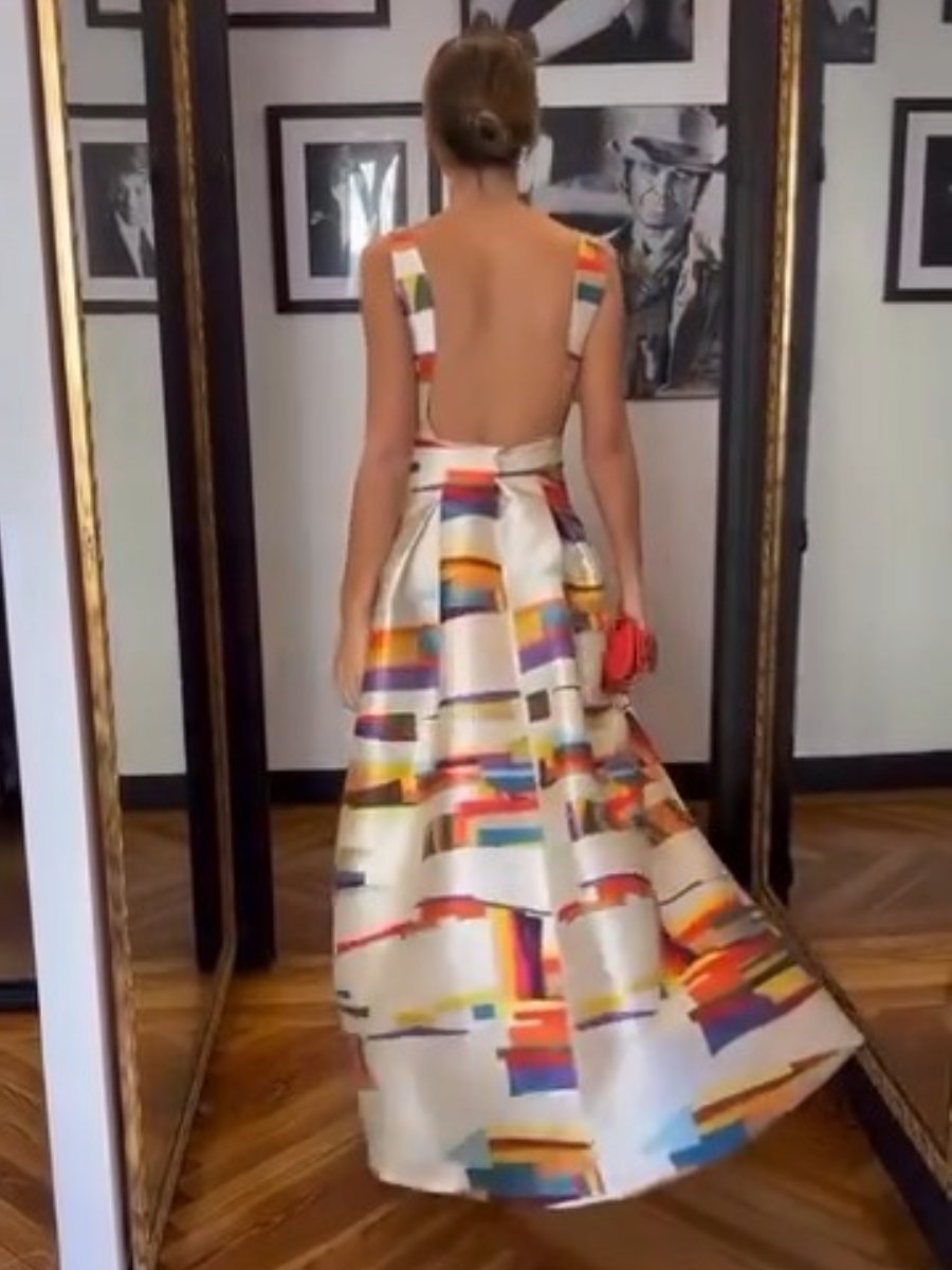 Back view of sleeveless evening dress with fitted waist and abstract multicolor full skirt