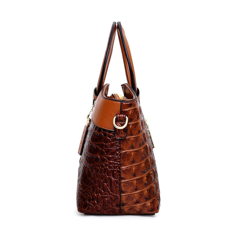 Brown croc-textured handbag side view with top handles and shoulder strap