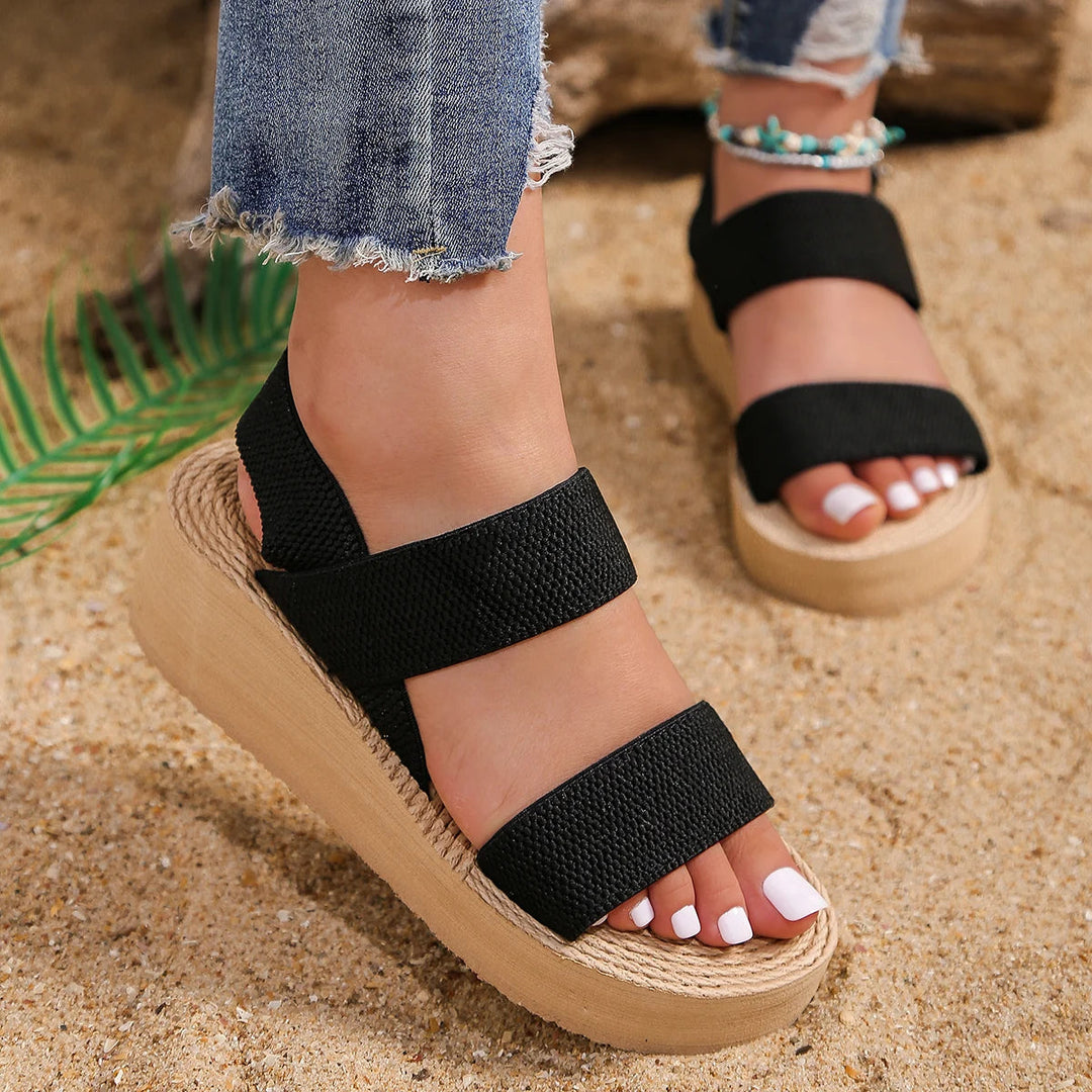 Black woven platform sandals with two wide straps and open toe