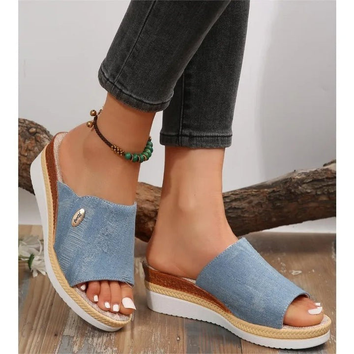 Blue denim ergonomic sandals with open toe and tan espadrille-style sole trim