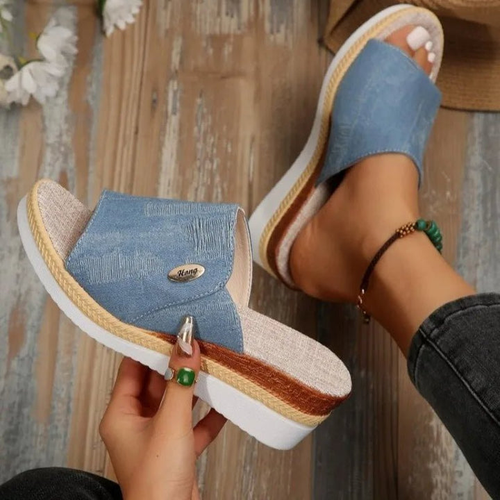 Light blue denim ergonomic sandals with open toe and tan espadrille-style sole trim