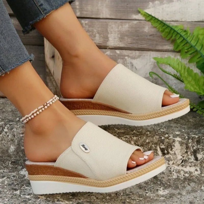Cream fabric ergonomic sandals with open toe and tan espadrille-style sole trim