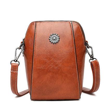 Brown mini crossbody handbag with zipper and sunburst emblem