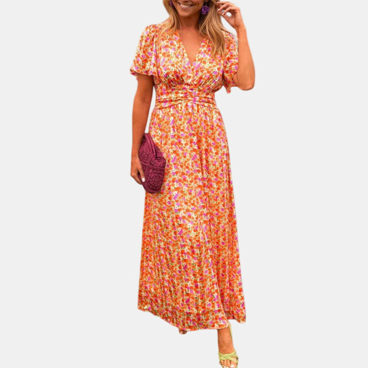 Floral maxi dress with V-neck, short sleeves, and smocked waist in orange pink