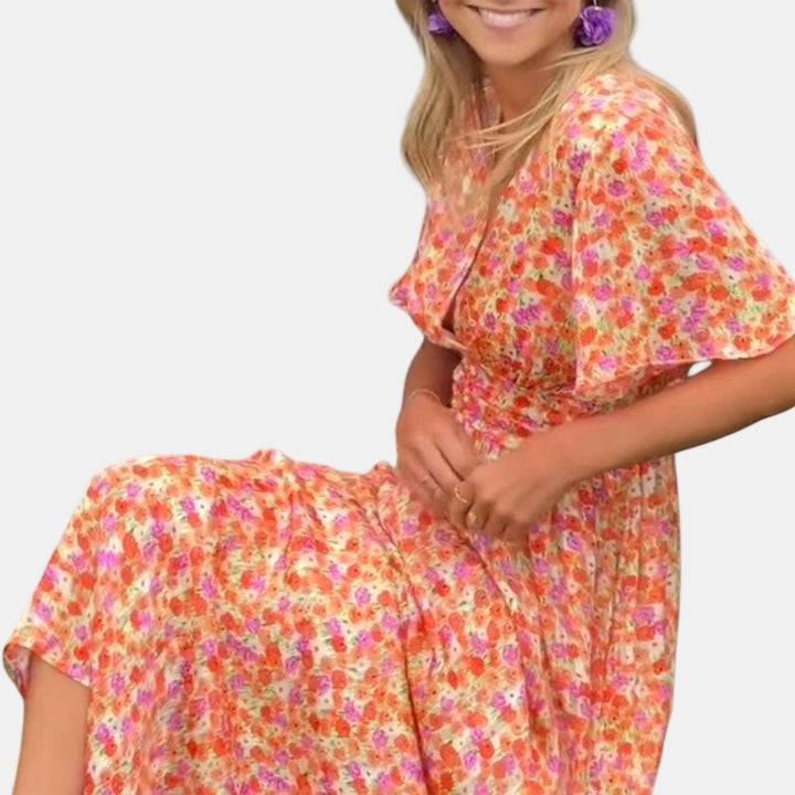 Floral maxi dress close-up with V-neck, flutter sleeves, and smocked waist