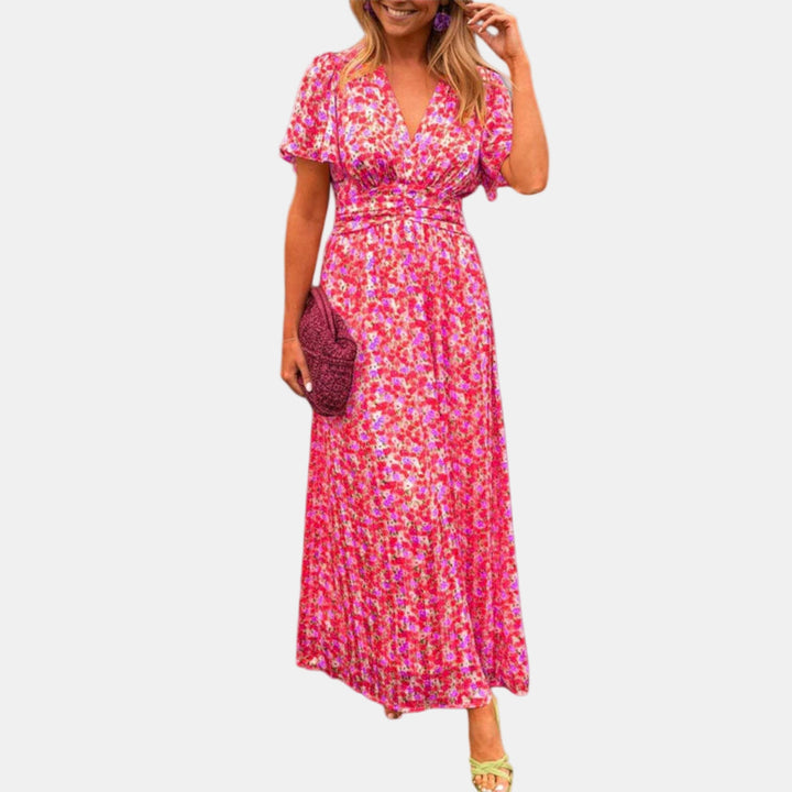 Floral maxi dress with V-neck, short sleeves, and smocked waist in magenta pink
