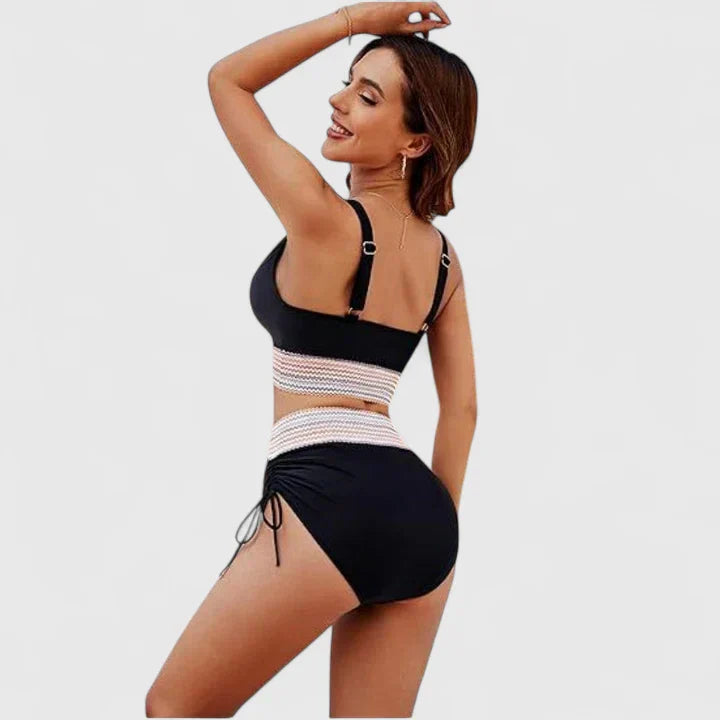 Women’s black bikini set side view with striped waist band and tie-side bottoms