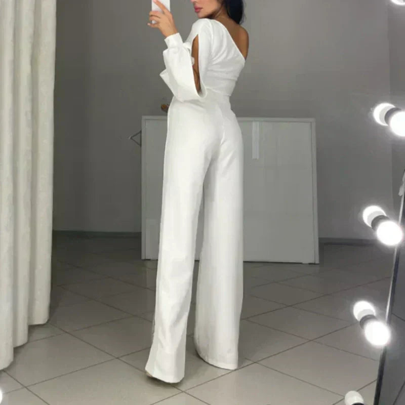 White one-shoulder flared romper with halter strap, long wide legs, and open back