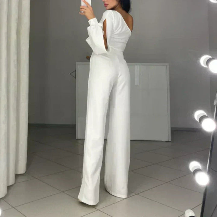 White one-shoulder flared romper with halter strap, long wide legs, and open back