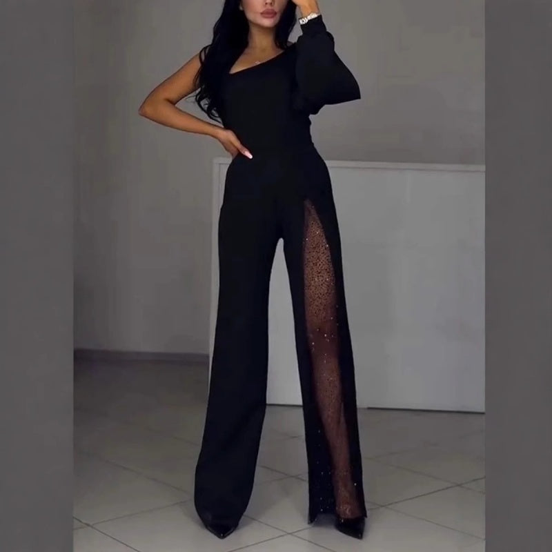 Black one-shoulder flared romper with sheer side panel and long wide-leg silhouette