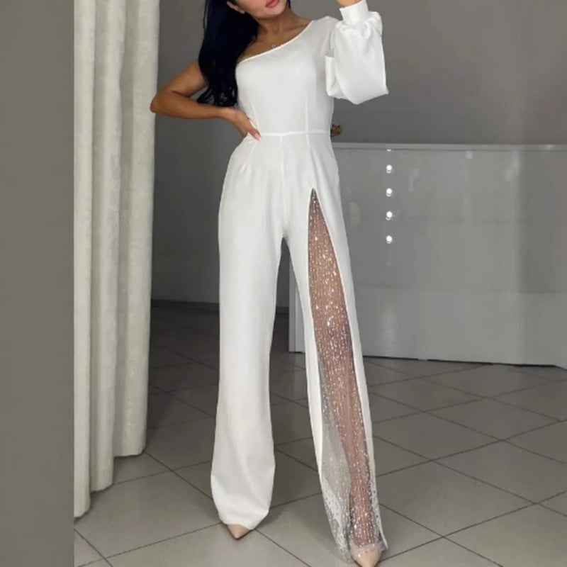 White one-shoulder flared romper with side slit and sparkly sheer panel along leg