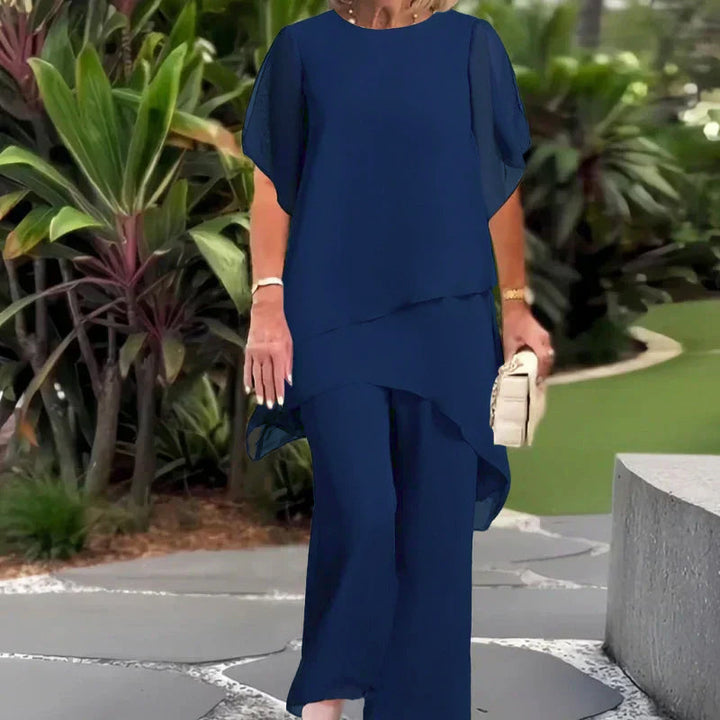 Navy two-piece set with layered short-sleeve top and flowy wide-leg trousers