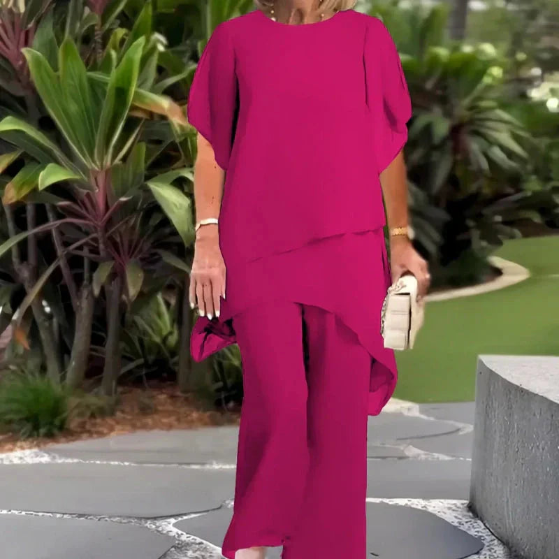 Pink two-piece set with layered short-sleeve top and flowy wide-leg trousers
