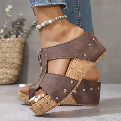 Brown wedge sandals with ankle strap, stud accents, and cork-look platform sole