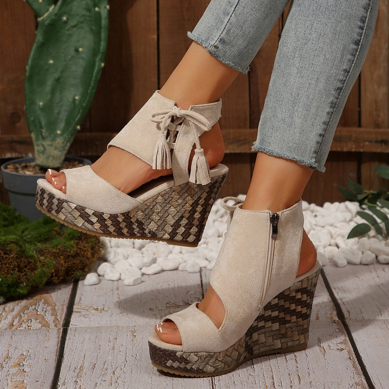 Beige suede wedge sandals with tassel ties and zip ankle, peep toe, patterned sole.