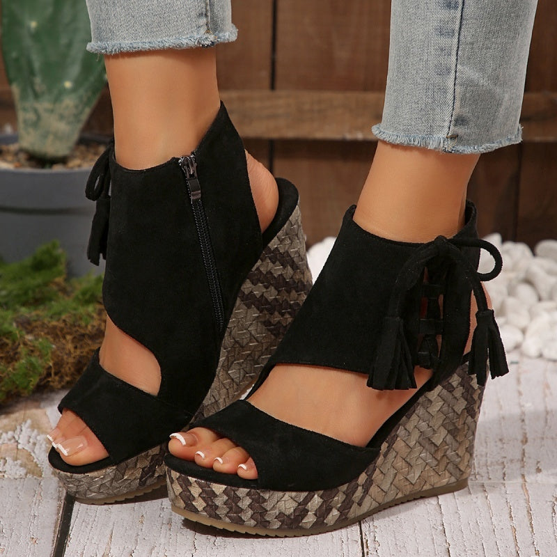 Black suede wedge sandals with zip ankle and tassel ties, peep toe, patterned sole.