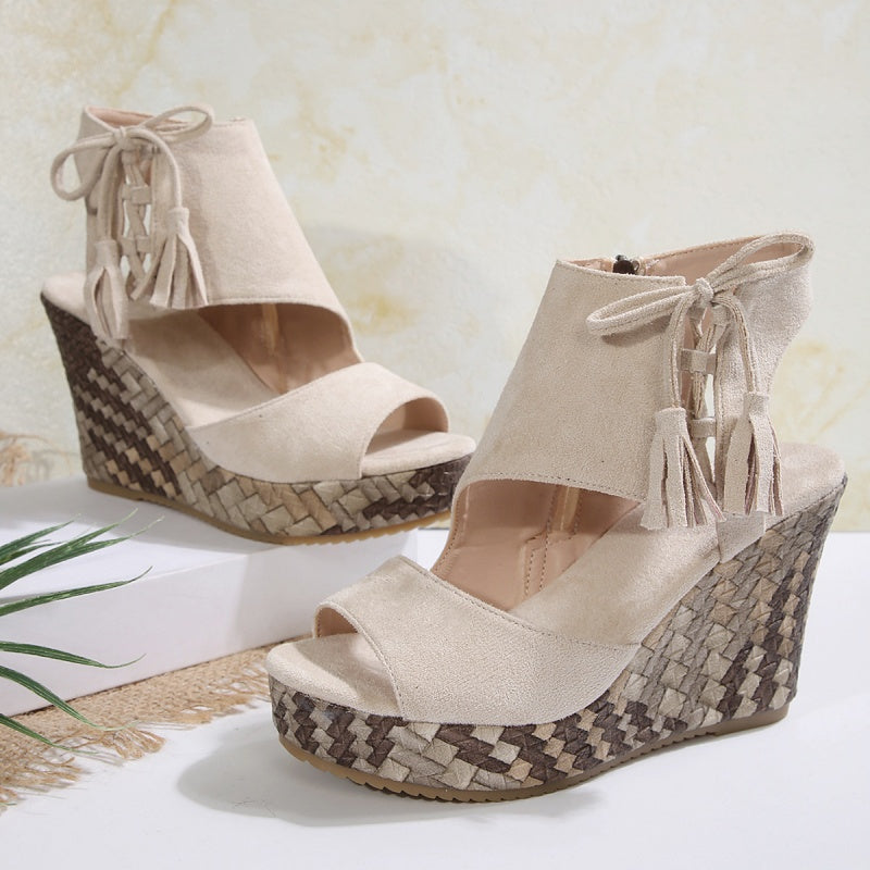 Light beige suede-look ergonomic sandals with tassel laces and woven wedge heel