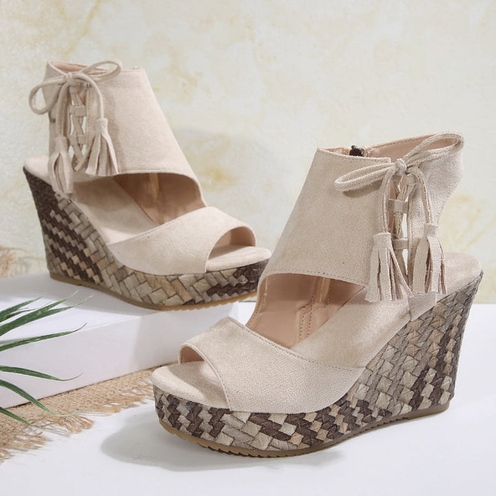 Light beige suede-look ergonomic sandals with tassel laces and woven wedge heel
