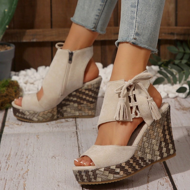 Beige suede-look ergonomic sandals with tassel laces and woven wedge platform