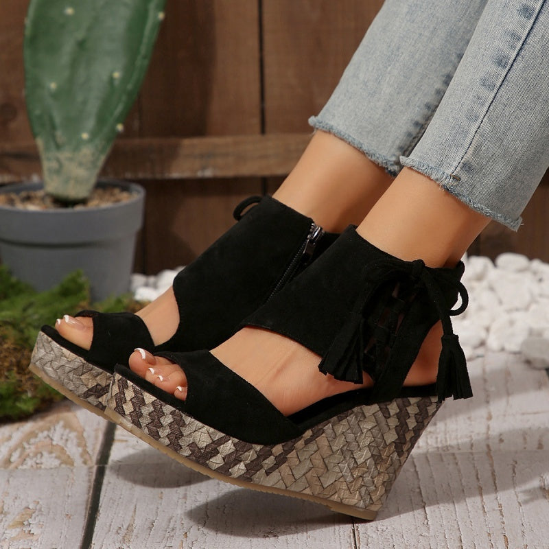 Black suede-look ergonomic sandals with tassel laces and woven wedge heel